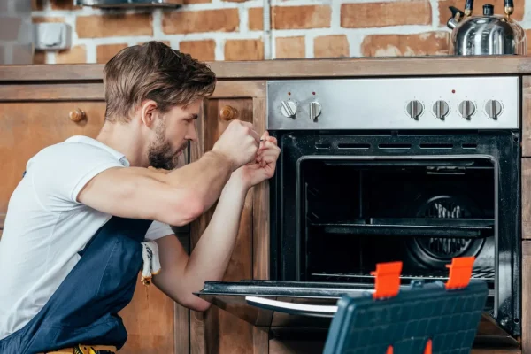 stock-image-man-fixing-oven
